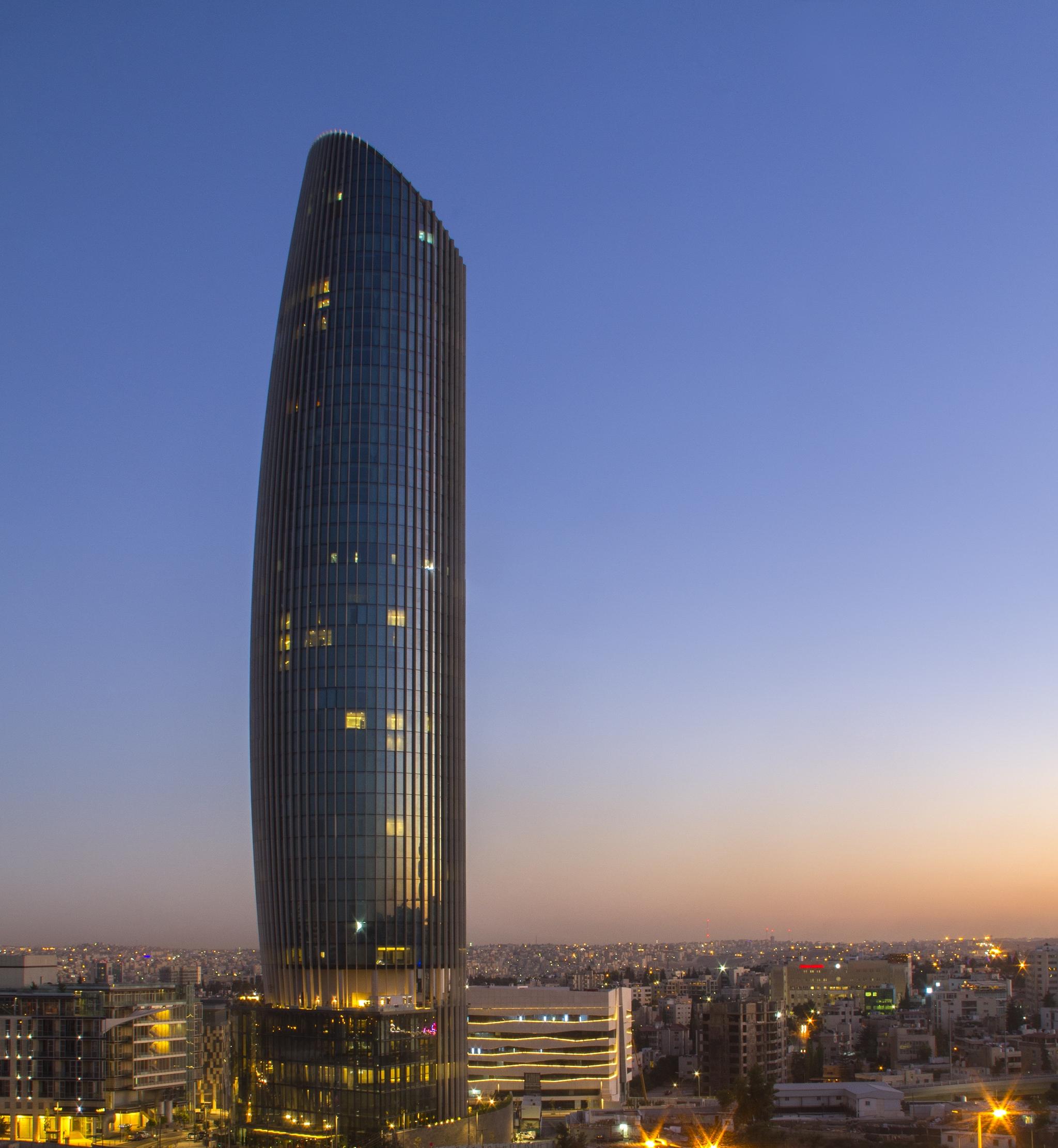 Отель Amman Rotana Экстерьер фото The tower at sunset